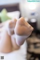 A close up of a woman's feet in white stockings.