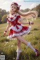 A woman in a red and white dress is walking in a field.