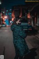 A woman wearing a mask standing in the middle of a street.